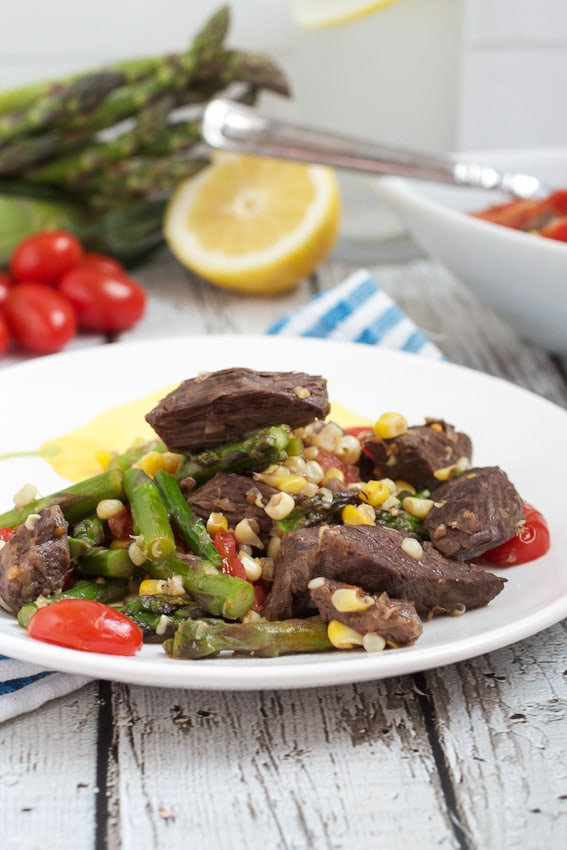Steak Stir Fry with Asparagus, Corn and Tomatoes from The Girl In The Little Red Kitchen