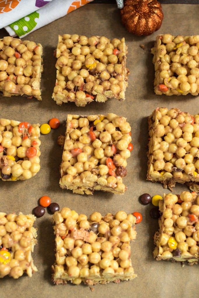 Reese's Marshmallow Cereal Bars from The Girl In The Little Red Kitchen | Filled with peanut butter Halloween candy and puffed peanut butter cereal, these no-bake bars are perfect to use up extra Halloween candy! 
