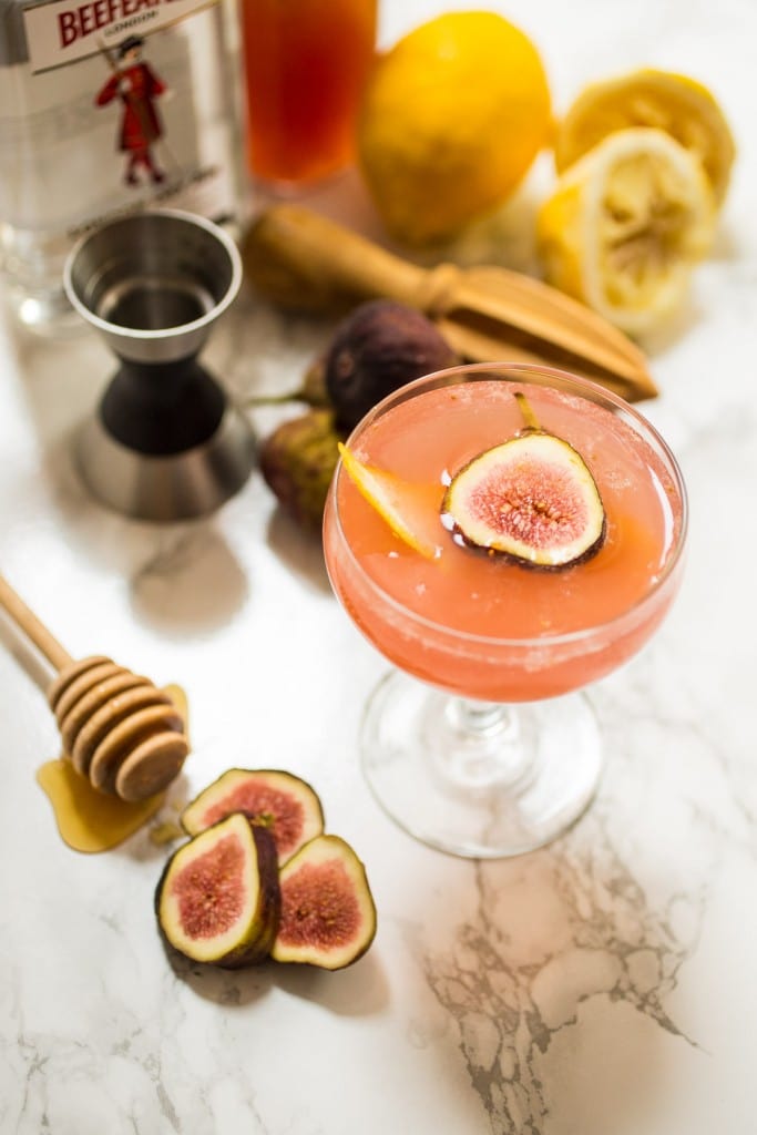 Fig Bees Knees from The Girl In The Little Red Kitchen | Fresh Figs, honey and gin get mixed together to make this pretty pink cocktail. 