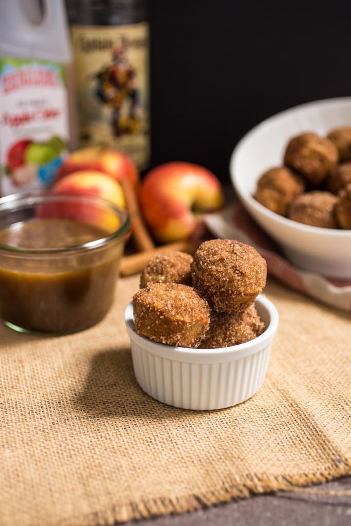  Apple Cider Donut Holes with Hot Buttered Rum Dipping Sauce from The Girl In The Little Red Kitchen | Keep your kitchen clean with these baked cider donuts and boozy spiked dipping sauce! 