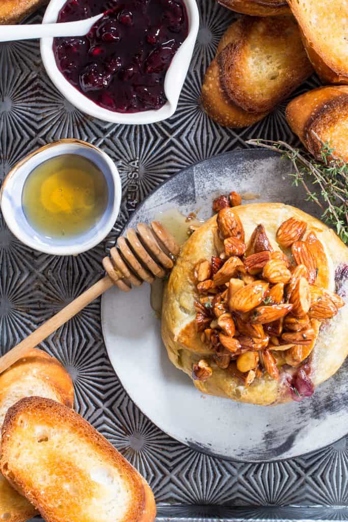 Brie en Croute with Honeyed Almonds, Cherries and Thyme | girlinthelitlteredkitchen.com
