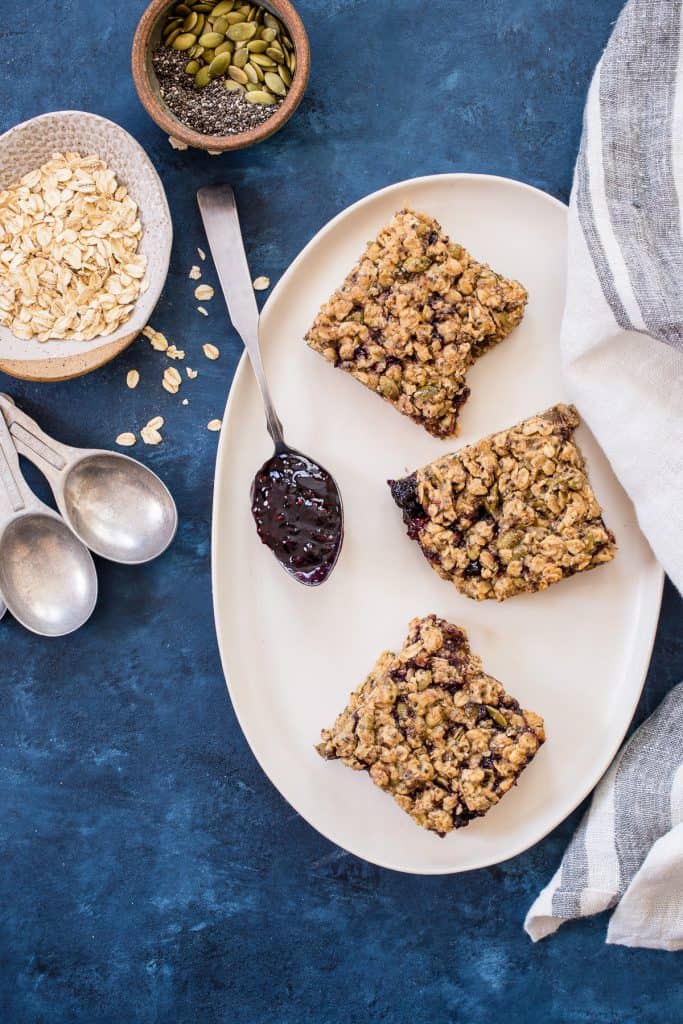 Soft and Chewy Baked Oatmeal Bars with Almond Butter and Jam | girlinthelittleredkitchen.com